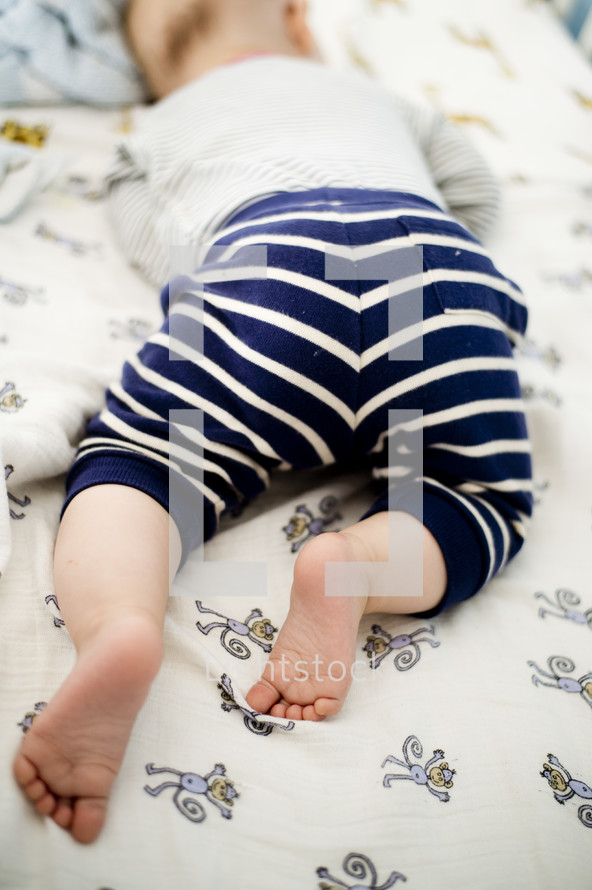 an infant sleeping on his stomach 