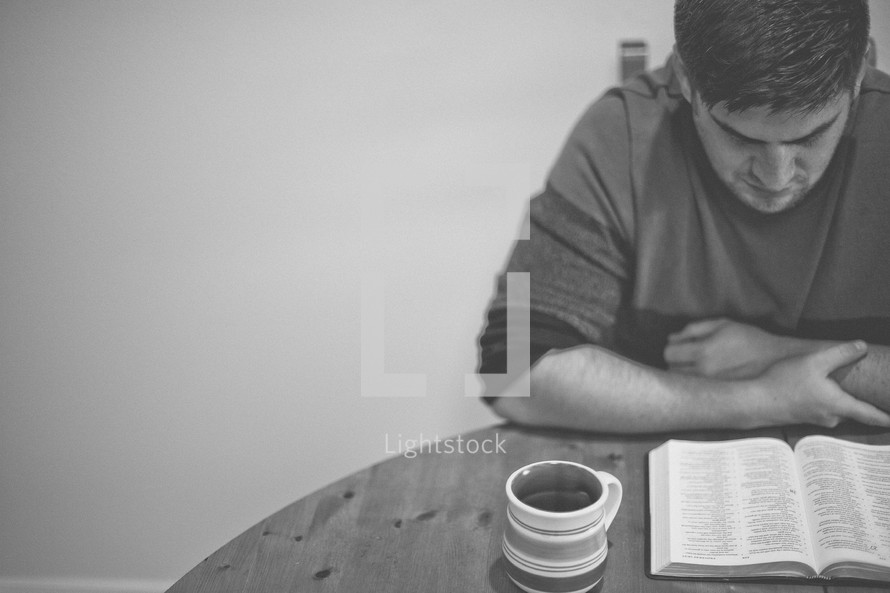 A man reading a Bible. 