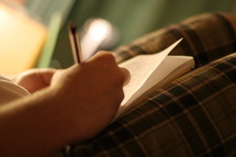 Man writing in notebook