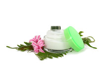 face cream with green leaves isolated on white background