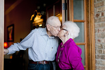 Elderly couple kissing