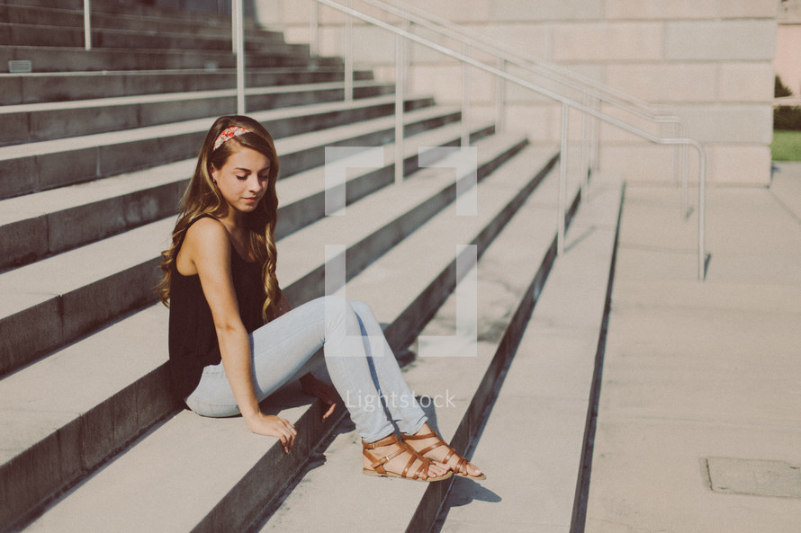 teen girl sitting on steps 