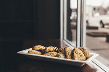 cookies on a plate in a window 