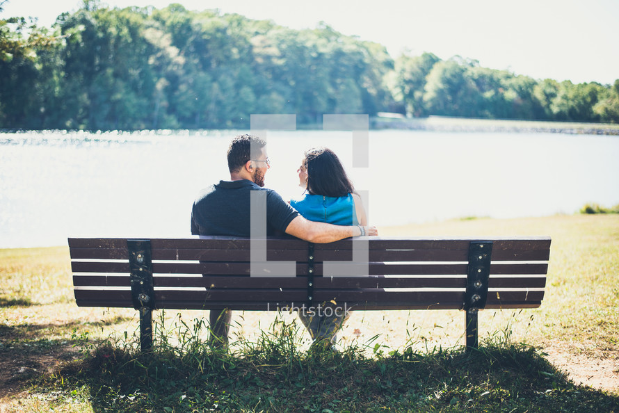 couple sitting on a park bench together 