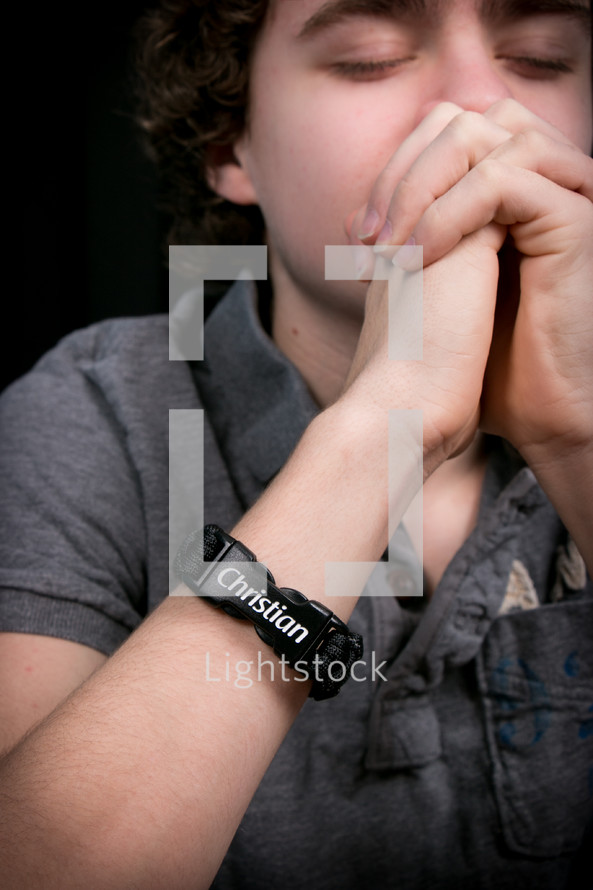 Teen boy praying.