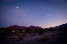 moon over mountains and desert 