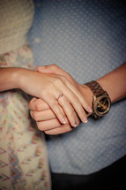 a young couple holding hands 