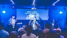 people singing on stage at a worship service 