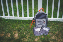 composition notebook in front of a gray book bag 
