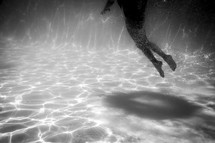 a girl swimming under water 