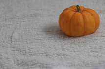 orange mini pumpkin on sand 