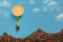 Abstract Hot Air Balloon from Espresso Cup and Miniature People. Mountains from Coffee Beans 