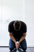 a man kneeling in prayer 