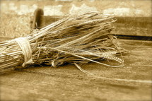 Bundle of wheat on old wooden table