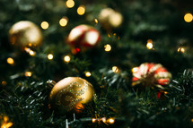 gold ornaments, pine garland, Christmas lights 