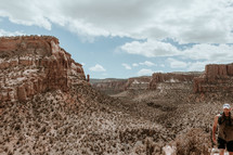 man exploring a desert canyon 