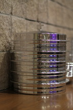 Stack of silver communion trays.
