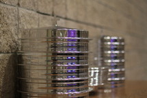 Stacks of silver communion trays.