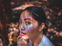 rainbow light reflection on a woman's face 