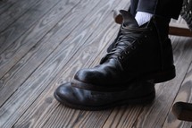 black boots, feet, wood floor