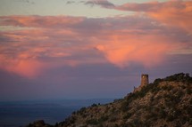 castle tower on a cliff at sunset 