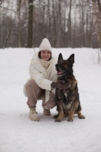 a woman with her dog in snow 