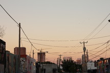 power lines and power poles and graffiti walls in a city 