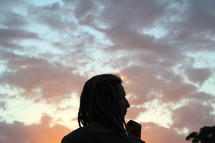 silhouette of a man with dreads at dusk 