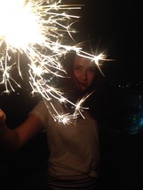a woman holding a sparkler