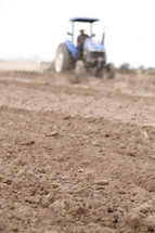 a tractor plowing a field 