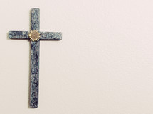painted cross with sunflower medallion and open copy space, cross decorated by the photographer