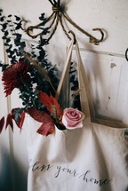 flowers in a bag hanging on a hook 