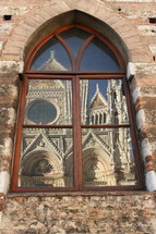 Reflection of Siena Cathedral in a window