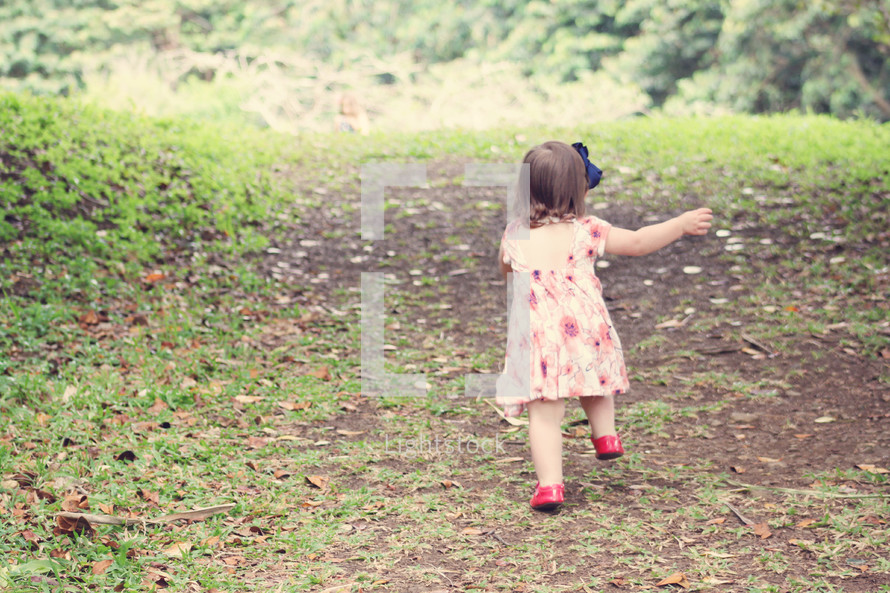 toddler girl running outdoors 