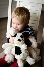 a child snuggling stuffed animals 