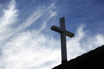 cross on a roof and blue sky