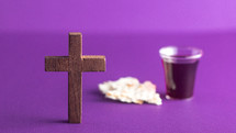 cross and communion elements on purple 