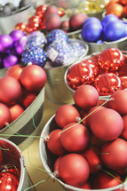 buckets of colourful Christmas ornaments