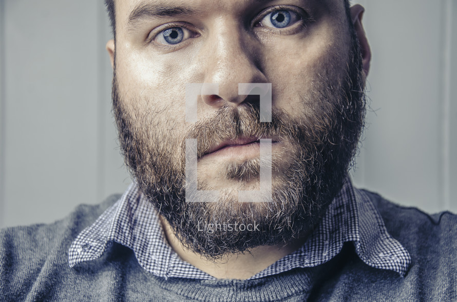 staring eyes of a bearded man 