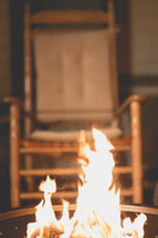 flames in a barrel and a rocking chair