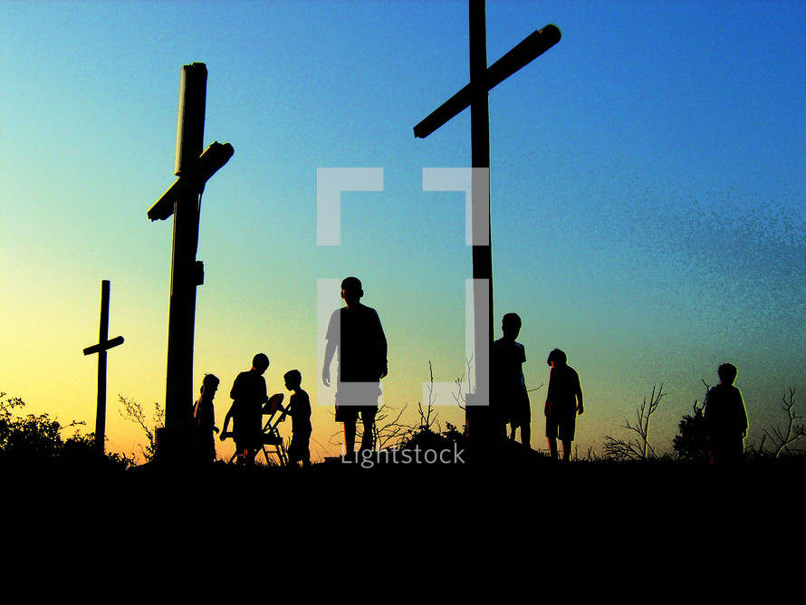 silhouettes of youth around crosses