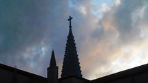 Chapel steeple against cloudy sky