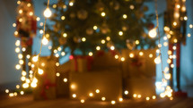 Blurred christmas tree with lights hanging background 