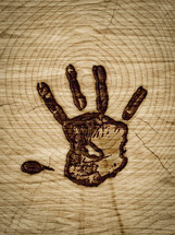 handprint branded into wood 