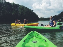 people paddling kayaks 