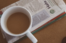 coffee mug on a newspaper 