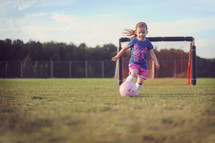 girl child playing soccer 