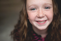 a smiling freckled face girl 