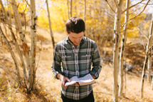 Man Outside Reading Bible During Fall 