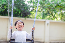 a happy child on a swing 